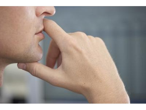 Man holding mouth