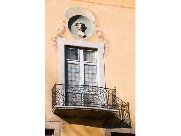 Fine lined-iron railings are like elegant pen strokes on the side of a plain wall.