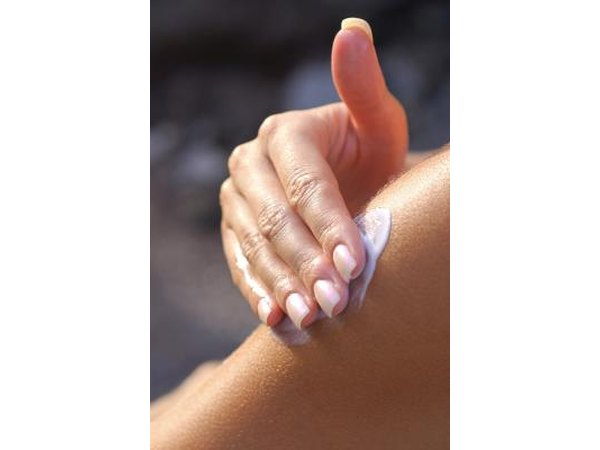 Girl putting lotion on skin