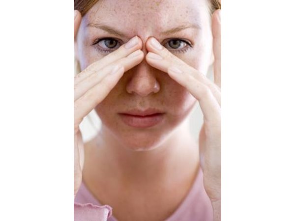 woman rubbing her sinuses