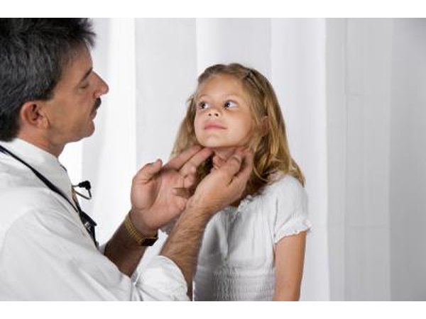 Doctor checking a child's lymph node