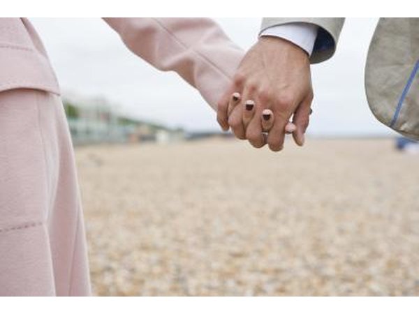 Couple holding hands on the beach