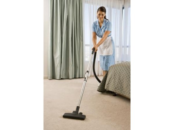 Hotel maid vacuuming