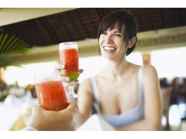 Woman toasting with strawberry daiquiri