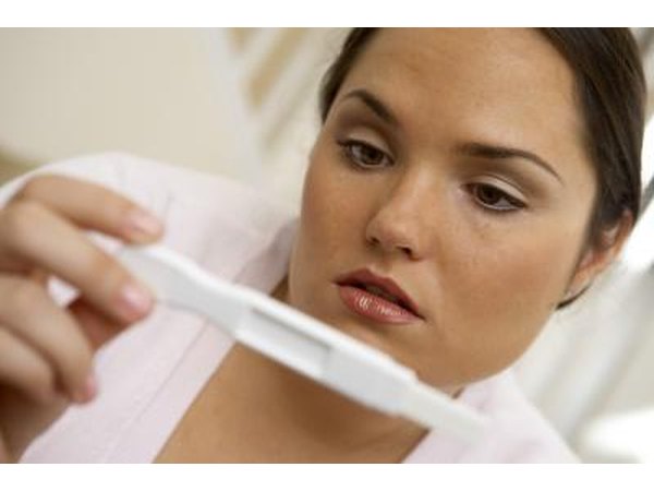 woman reading pregnancy test