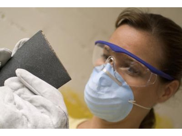 Woman wearing goggles and dust mask