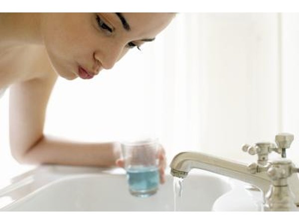 Young woman using mouth wash