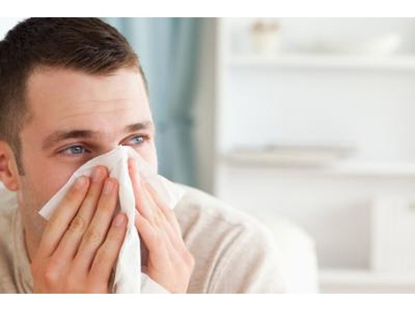 man blowing his nose