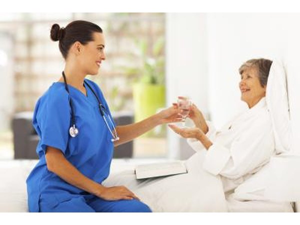 elderly woman drinking water in hospital