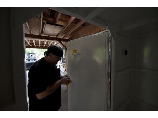 Man puts final touches to storm safe room door in Neosho, Missouri