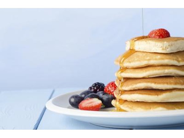 Stack of pancakes topped with berries.