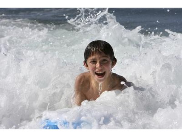 Boy playing in ocean