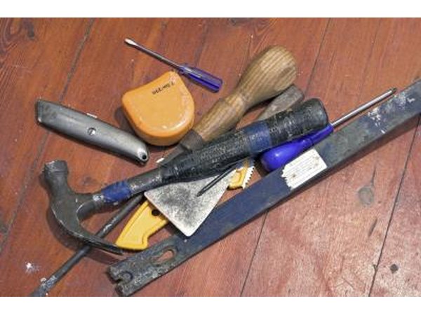 Use a flat pry bar to remove the nails from the shingles you just marked.