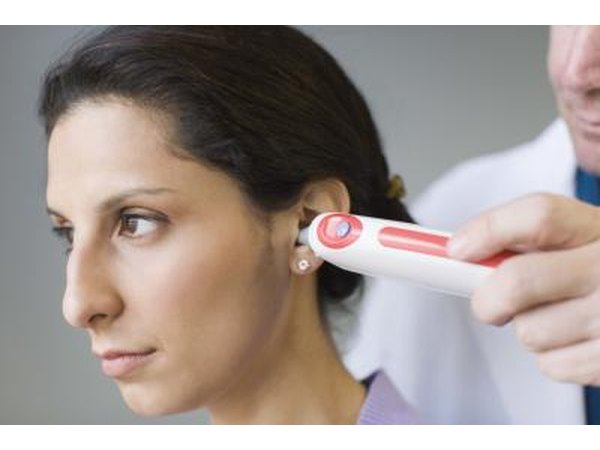 Doctor taking woman's temperature