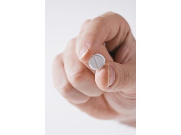 Man with pill in his hand