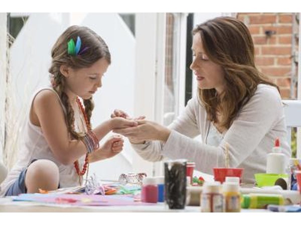 Girl making crafts with Mom