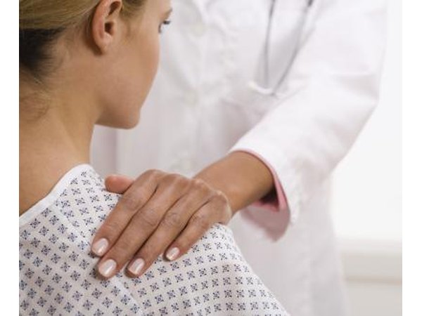 A doctor examines a female patient.