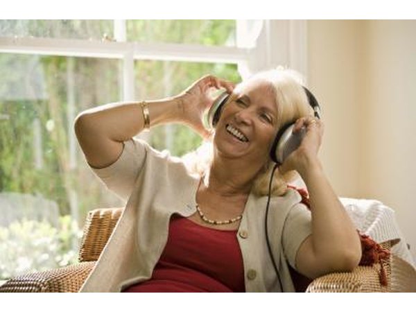 Mature woman wearing headphones