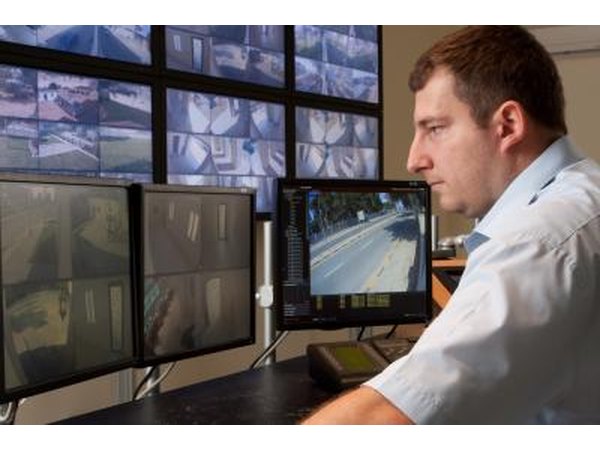 Security officer watching security cameras