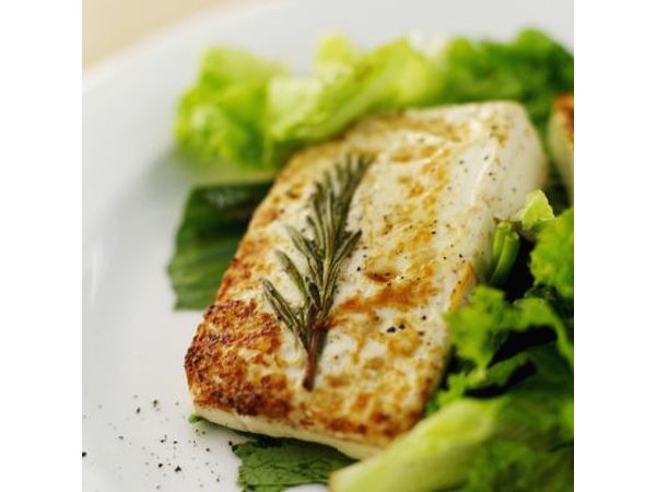 A piece of grilled fish and salad.