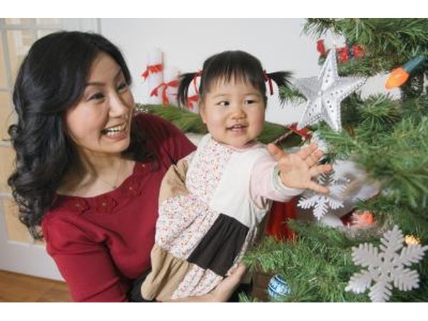 Mother and child next to tree with ornaments