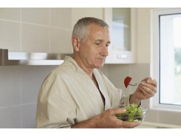 Man eating in his kitchen