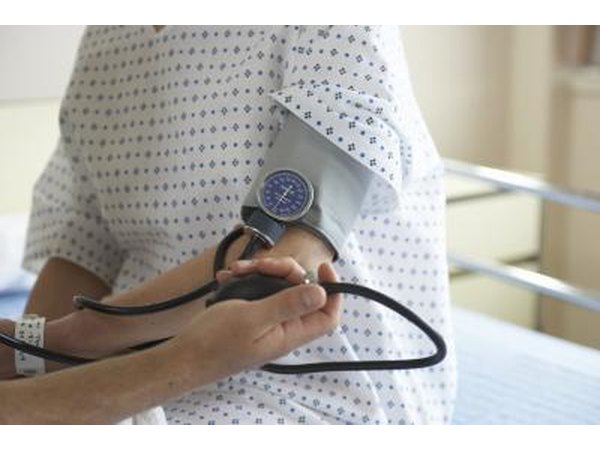 Doctor testing patients blood pressure