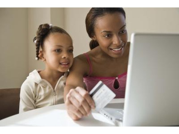 Little girl online shopping with Mom
