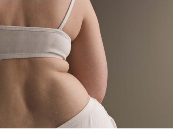 Rearview of overweight woman in undergarments.