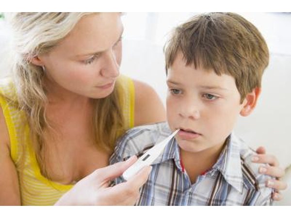 Mother taking son's temperature