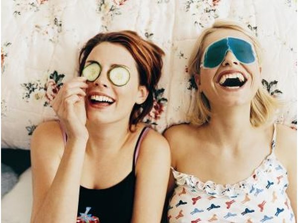 Teenage girls laughing on bed