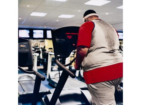 Man viewing heart monitor on exercise machine