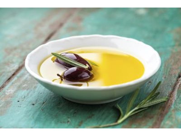 Bowl of olive oil with olives