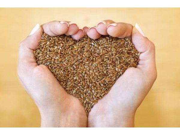 Hands holding flaxseeds.