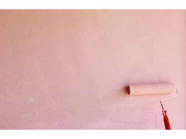Painting a wall pink.