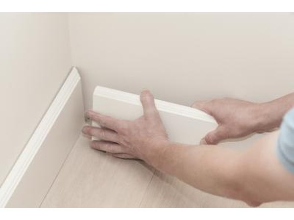 White baseboard being installed.