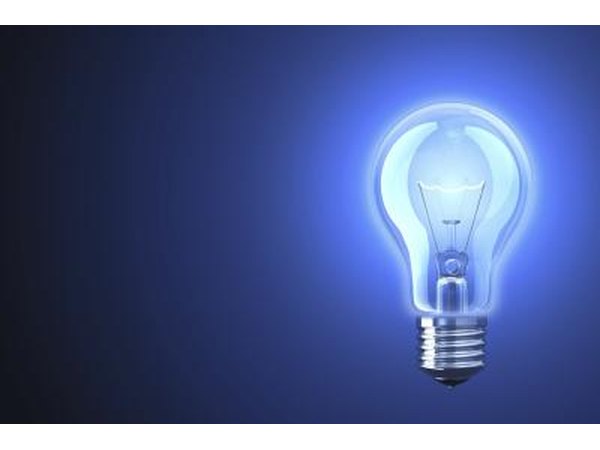 Incandescent light bulb on blue background.