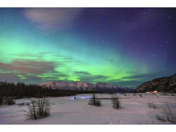 The aurora borealis is seen looking over Knik River in Alaska.