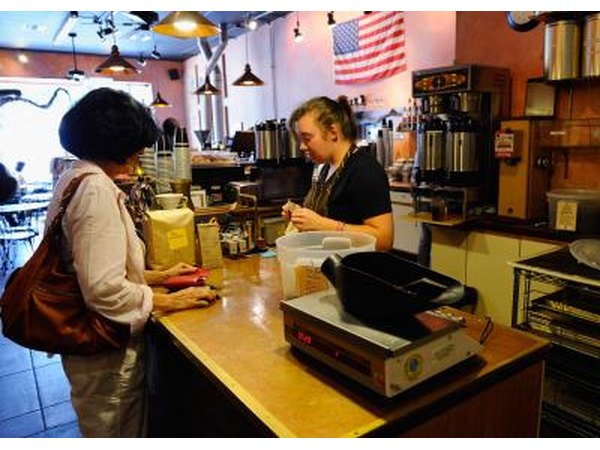 Barista helping customer at counter