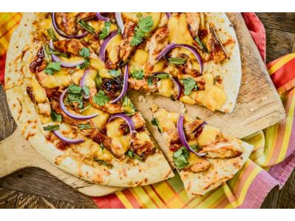 Pizza with chicken, cheese, red onions and cilantro