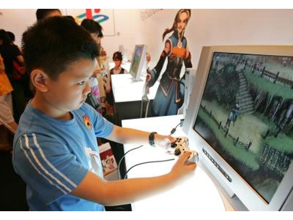 Young boy playing with PlayStation 2 game system
