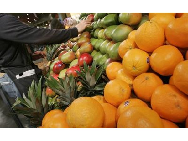 Grocer handling mangoes