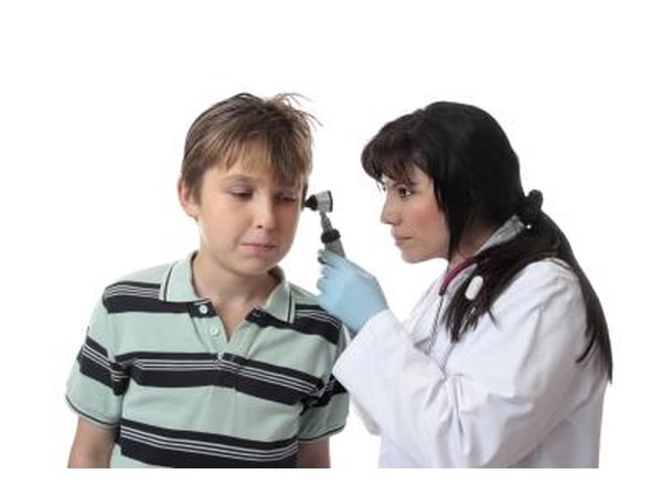 Looking inside ear for infection.