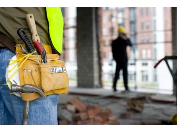 A close-up of a worker wearing a tool belt.