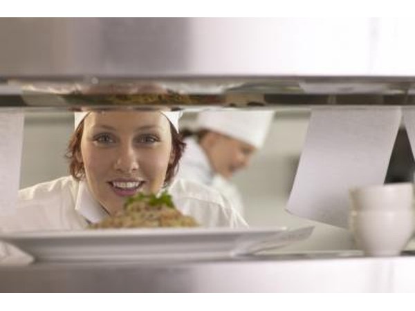 A chef is finishing up a dish.