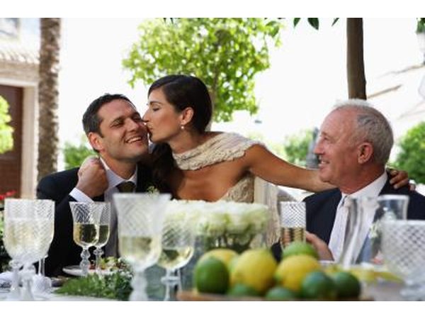 Newlywed couple with father of groom.