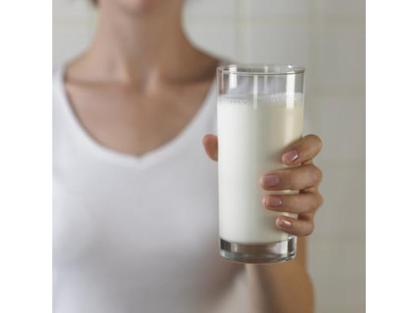 A woman drinks a. Glass of milk.