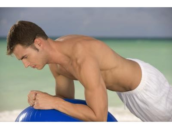 Man in plank exercise position with balance ball.