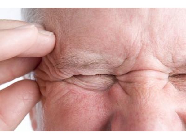man with headache on side of head