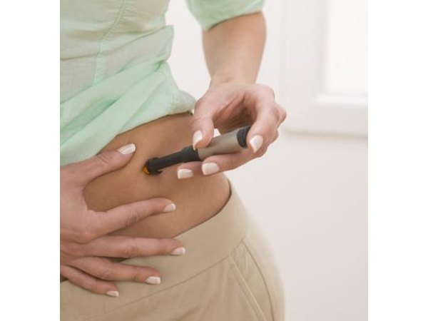 Diabetic woman administering an insulin shot